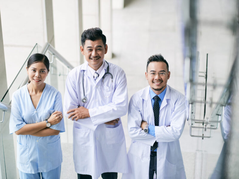 Portrait of joyful medical people standing with thair arms crossed